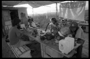 Activists eating at a makeshift table at the Nevada Test Site peace encampment