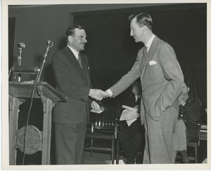 Governor Dewey shaking hands with client at Institute Day