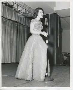 Unidentified woman in gown singing at Thanksgiving celebration