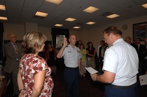 Commander Mark Fedor (center), US Coast Guard, being sworn in as Special Detailee to House Appropriations Committee, Congressman John W. Olver (far left) in background