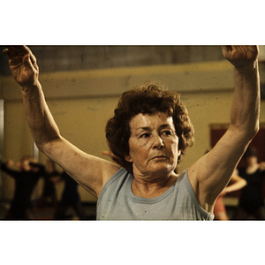 Woman stretching her arms up in a gym