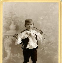 Boy in fancy jacket, holding a whip