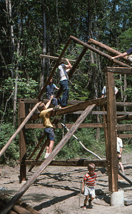 Bracing sets of rafters at southern end of barn at the Moon Barn Raising at entrance to Hopkins Forest on 2 August 1975.