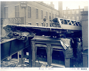 Wreck at Dudley Street, view from tracks of car lodged in building being dismantled