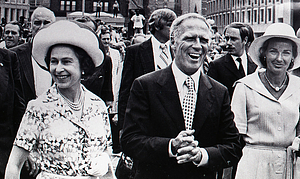 [Queen Elizabeth II, Mayor Kevin White, and Kathryn White walking in a parade]