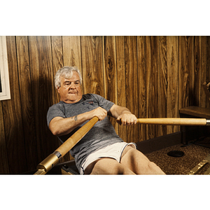 Man exercising with a rowing machine