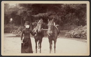 Lydia Paine leading two horses