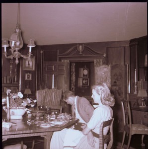 Man and woman seated at dining room table, Beauport, Sleeper-McCann House, Gloucester, Mass.
