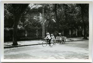 Cyclist and man hauling wagon, Old Quarter