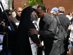 Greek Orthodox Archbishop Demetrios greeting Jesse Jackson with a kiss during the march opposing the War in Iraq