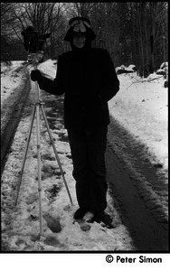 Unidentified woman in the snow with 16mm motion picture camera