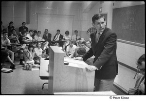 National Student Association Congress: man speaking at podium, Allard Lowenstein seated on right, just out of frame