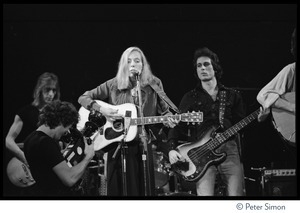 Joni Mitchell performing at the Harvard Square Theater, Cambridge, with the Rolling Thunder Revue