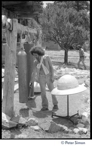 Man standing among the gongs, Lama Foundation