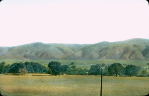 Plains and foothills, with telephone wire in foreground