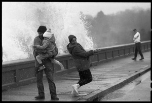 Judy Salonia, her husband Vincent, and daughter Ashley (4) dodge a wave crashing over the Narragansett seawall