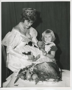 Susan Rainer feeding turkey to Susie Renken