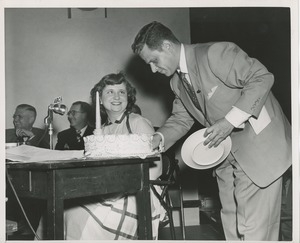 Unidentified man taking a slice of cake during a Club Can Do recording at ICD