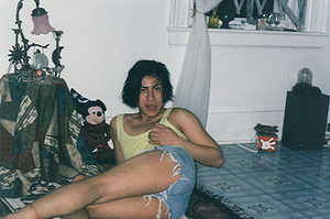 A Photograph of Melissa Posing in a Tank Top and Jean Shorts