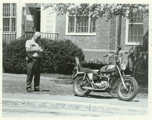 Unidentified campus police officer writing parking ticket