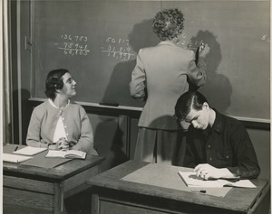 Miss R.L. Brady teaching math to a young woman and man