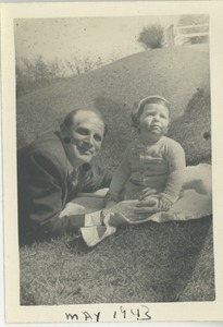 Unidentified man and child in grass