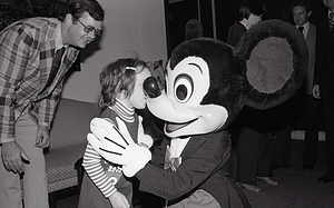 Child with Disney character Mickey Mouse