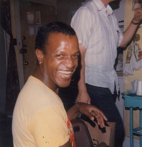 A Photograph of Marsha P. Johnson in a Yellow T-Shirt, Laughing