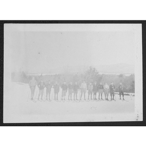 Group portrait of people lined up on skis