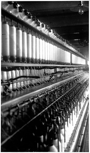 Spinning frame in the spinning room of a textile mill. [03]