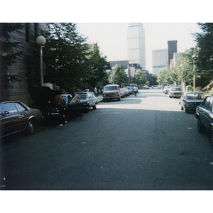 Street in the Villa Victoria neighborhood, with skyscrapers of downtown Boston visible in the background.