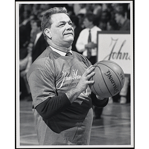 Daniel Kerrigan, father of the former Olympic skater Nancy Kerrigan, preparing to shoot a basketball at a fund-raising event held by the Boys and Girls Clubs of Boston and Boston Celtics