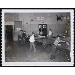 Boys play table tennis in a hall