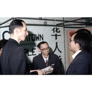 Members of the Chinese Progressive Association speak to a visiting Chinese diplomat at the organization's office in Boston