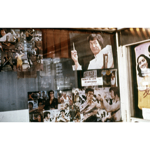 Store window advertising Bruce Lee posters for sale