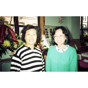 Two women smile for the camera at the Chinese Progressive Association's 13th anniversary celebration