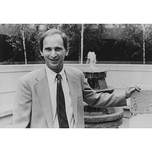 Law School dean Daniel Givelber poses in front of a fountain