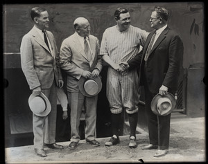 Babe Ruth in uniform with three unidentified men