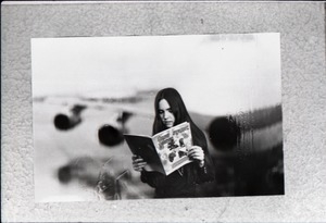 Heidi Bushell reading a copy of Free Spirit Press (vol. 1, 4) at the airport: manipulated copy print inserting image of airport in background