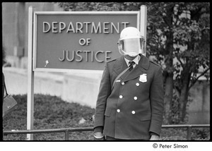 Member of the Civil Disturbance Unit in front of the Department of Justice