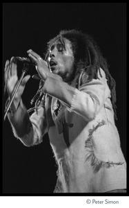 Bob Marley in concert, signing at the microphone