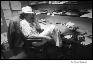Rolling Stone writer (?) seated at his desk, with typewriter