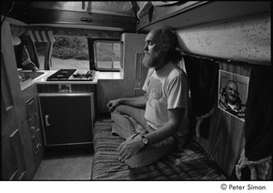 Ram Dass in his van: Ram Dass meditating next to a picture of Neem Karoli Baba