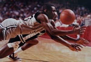 Basketball players from Providence College and Georgetown scrap for a loose ball in NCAA tournament