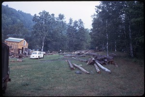 Lumber stacked in front of house