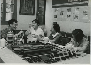 Shirley Graham Du Bois with two unidentified woman and one man sitting at a table