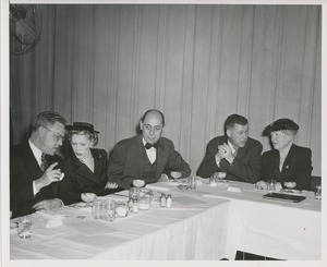 A group sits at a table at the Institute for the Crippled and Disabled's 35th anniversary Red Cross luncheon