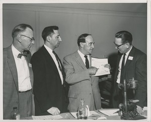 Attendees look at the jewelry test sheet for ICD clients at the 1959 Rehabilitation Counselors Conference