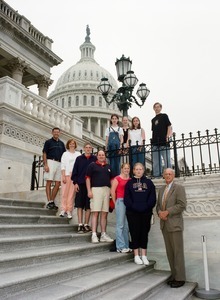 Congressman John W. Olver with group of visitors, posed on the steps of the United States Capitol building