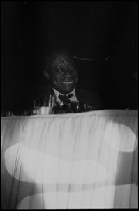 James Baldwin seated on stage at his birthday celebration